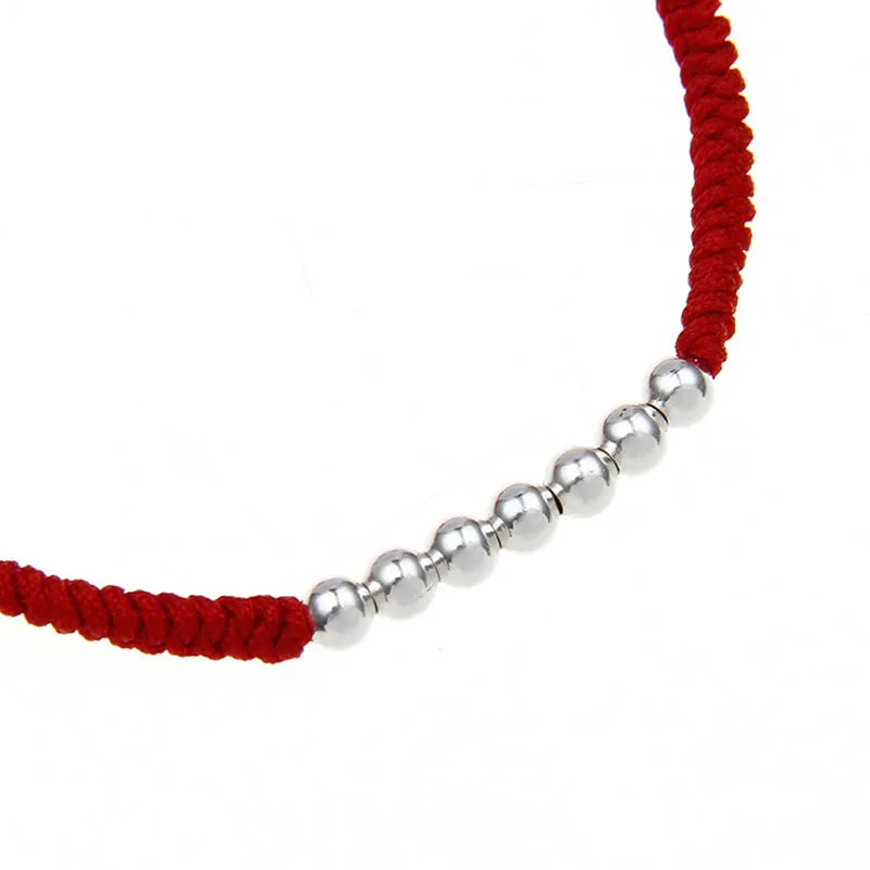 Pulsera Hilo Rojo con nudos y esferas plateadas