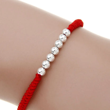 Pulsera Hilo Rojo con nudos y esferas plateadas